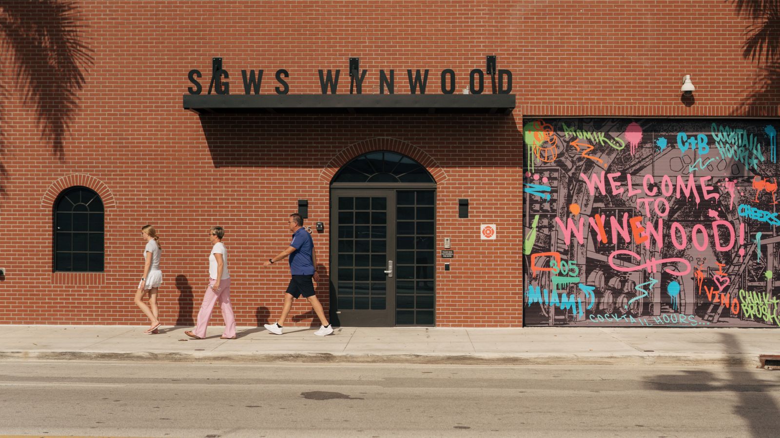 Wynwood Miami streetscape near DUOS Wynwood at 335 NW 28th Street, with a Welcome to Wynwood mural on a warehouse wall
