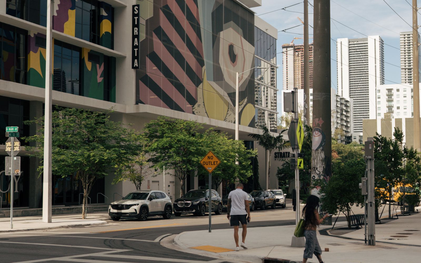 Street view of low-rise Wynwood warehouse blocks with painted facades