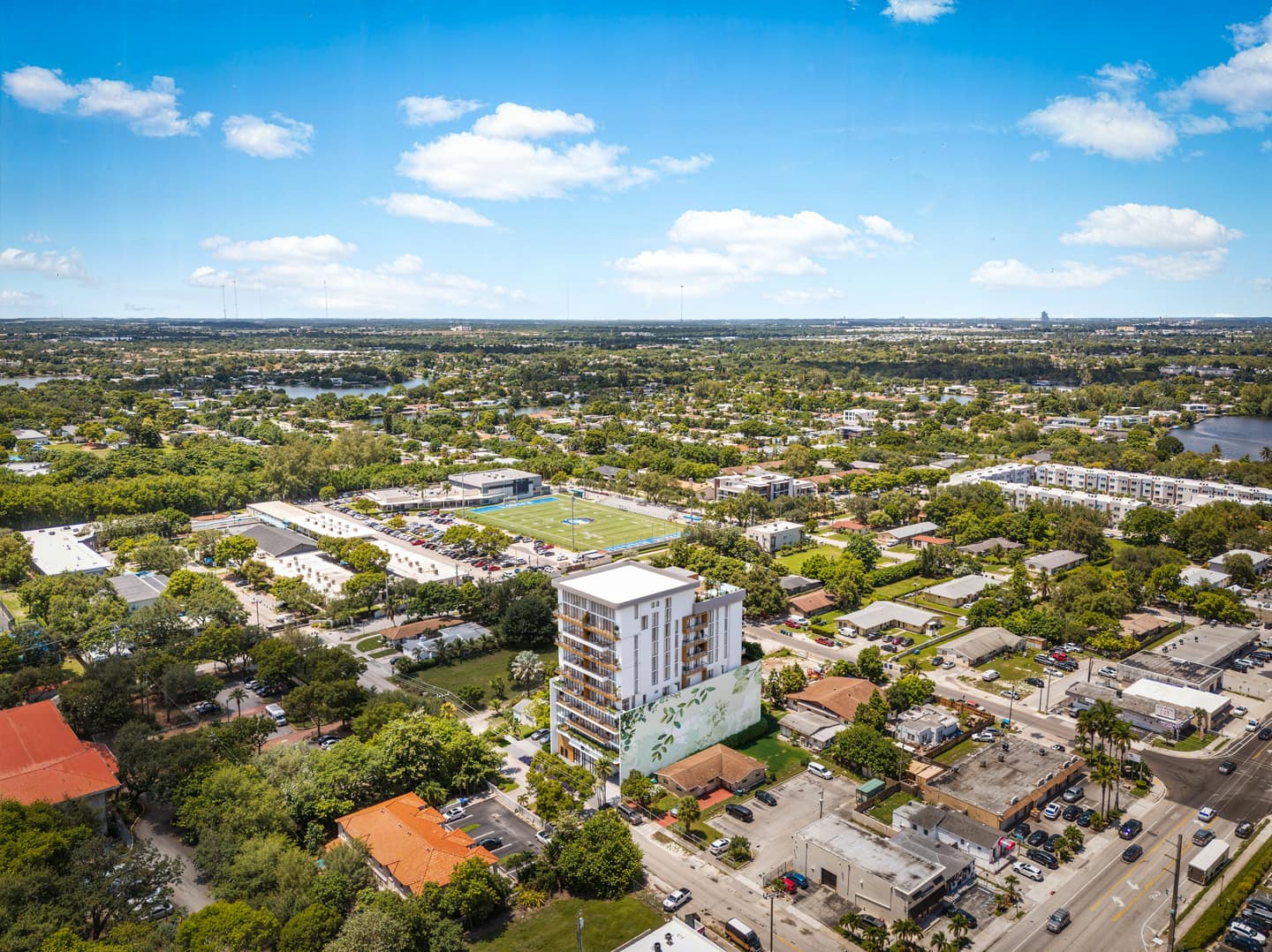 Northwest aerial rendering of Eden Residences showing the 10-story boutique building in its Ojus block context