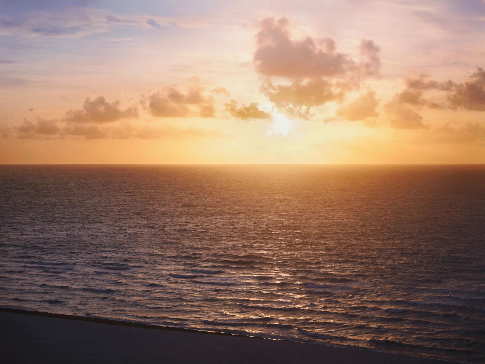 Sunset over the Atlantic beach and ocean horizon fronting Ocean Terrace Residences Miami Beach