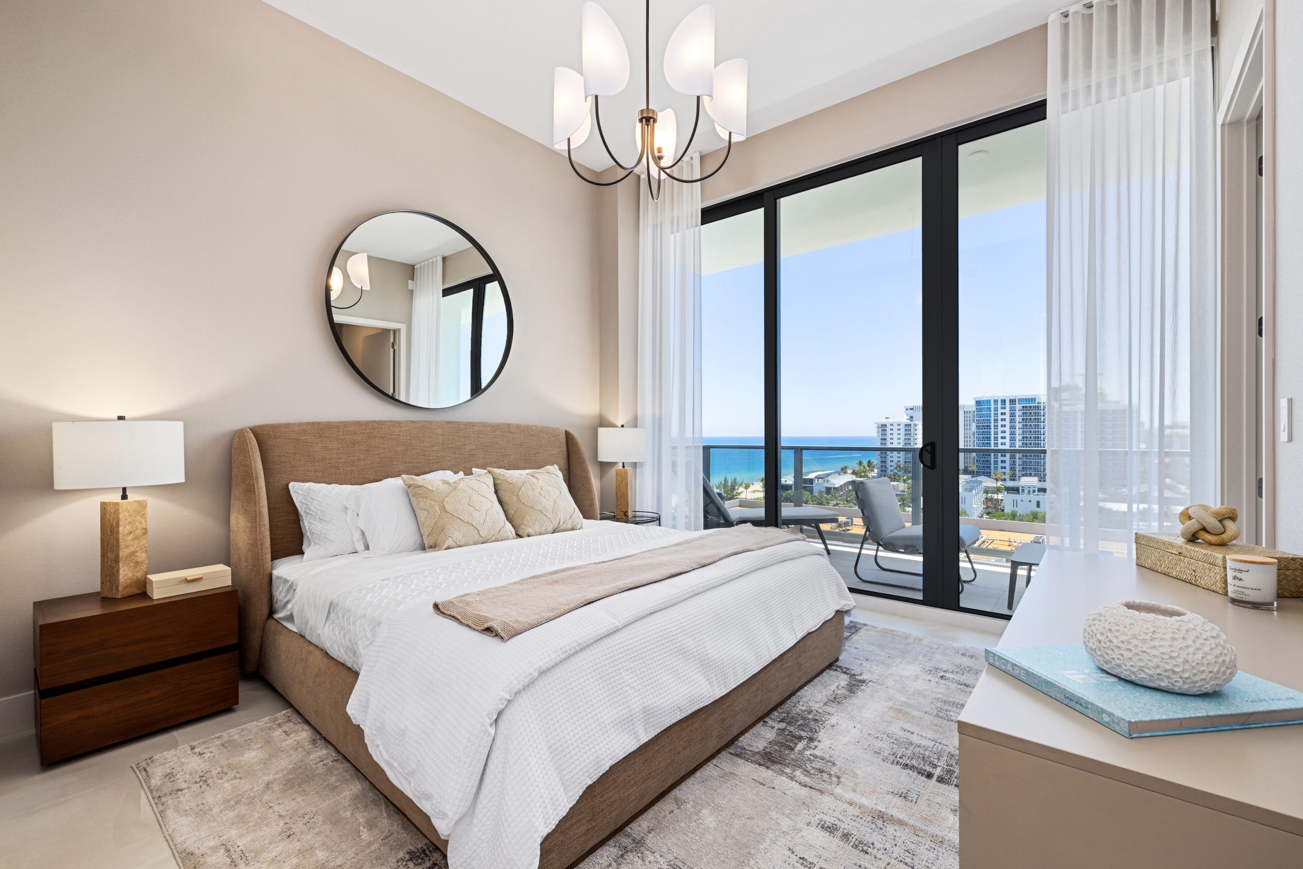 Bedroom at Salato Pompano Beach with floor-to-ceiling sliding glass doors opening onto a terrace above the Pompano Beach coastline