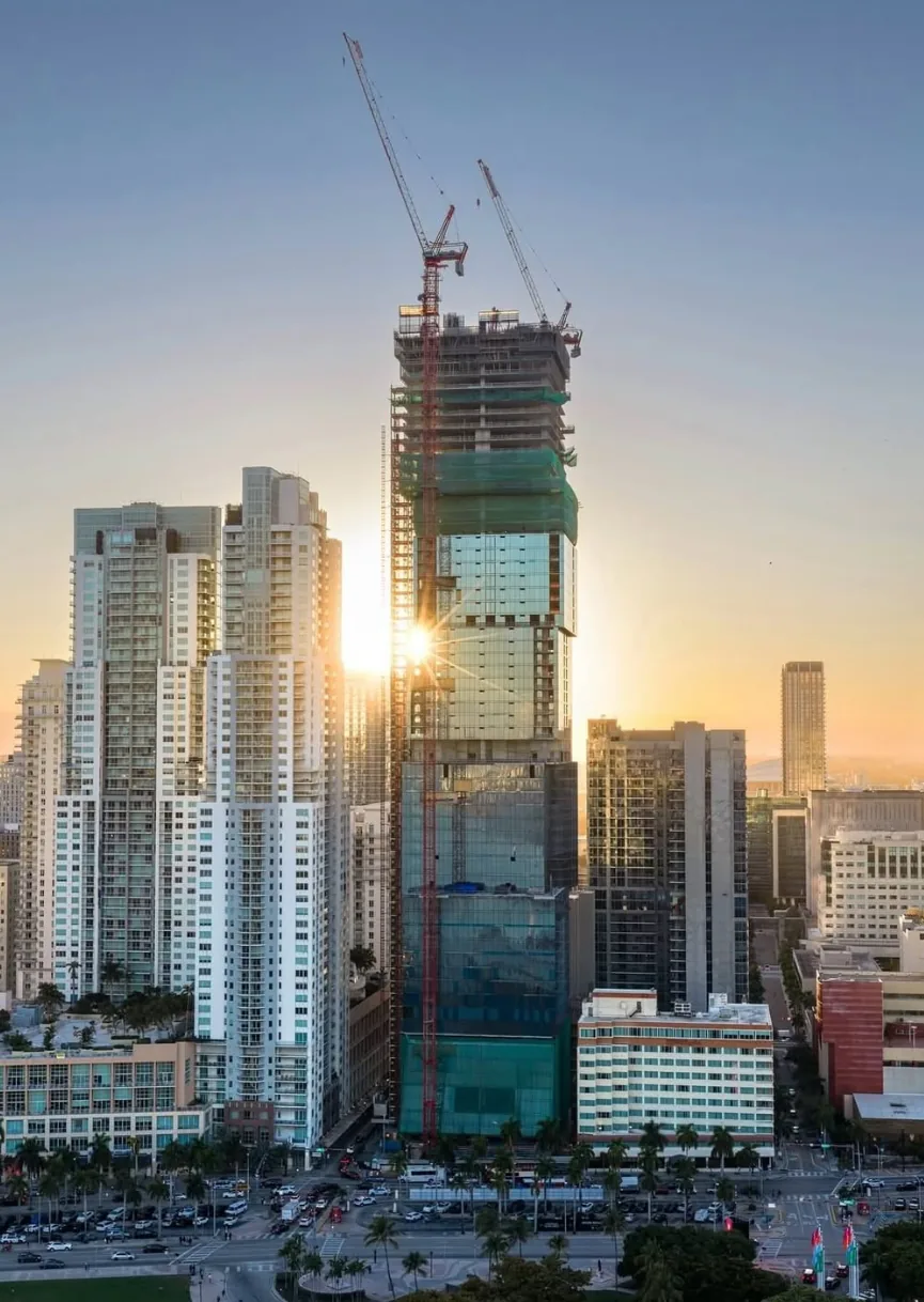 Waldorf Astoria Residences Miami at sunset, upper cubes under construction, downtown Miami skyline