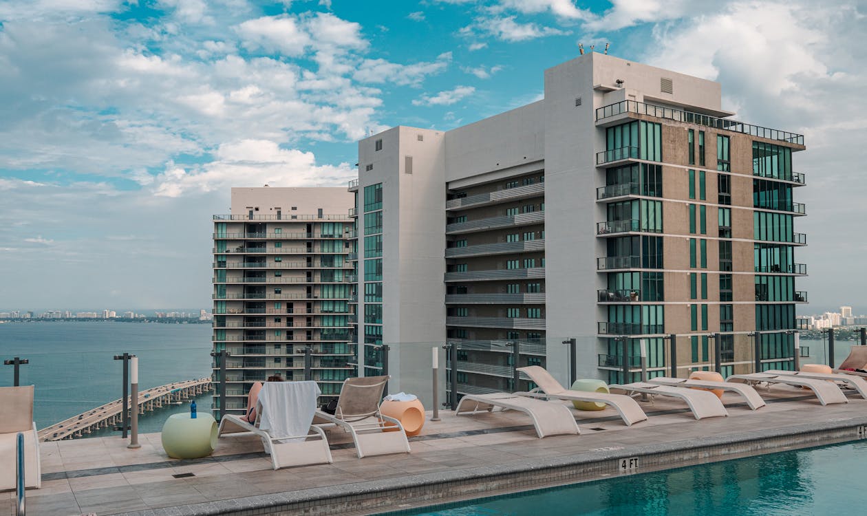 Rooftop pool deck overlooking Biscayne Bay, the type of recovery and wellness amenity SIRO Brickell is built around