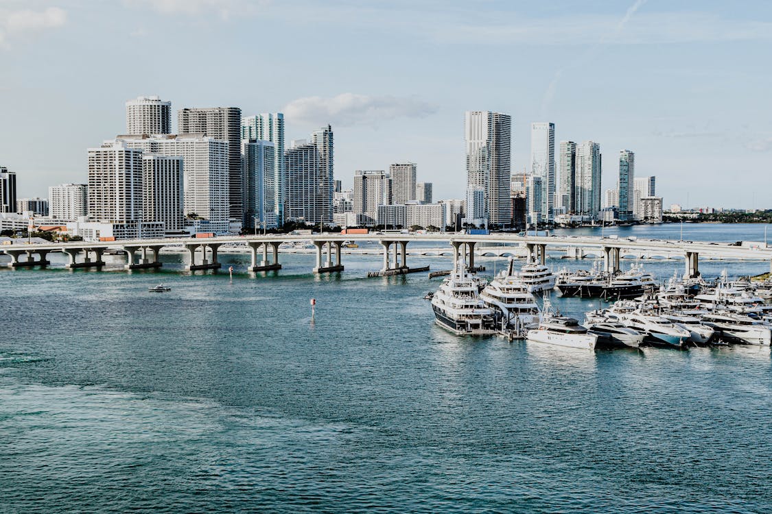 Miami skyline with marina, megayachts, and high-rise condo towers across Biscayne Bay