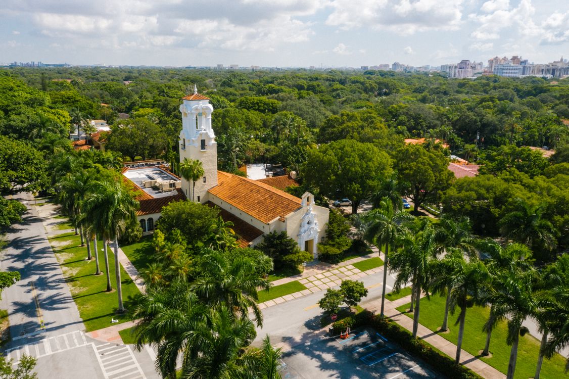 Aerial of Coral Gables landmarks and palm-lined streets, a supply-constrained submarket where disciplined projects still secure construction financing