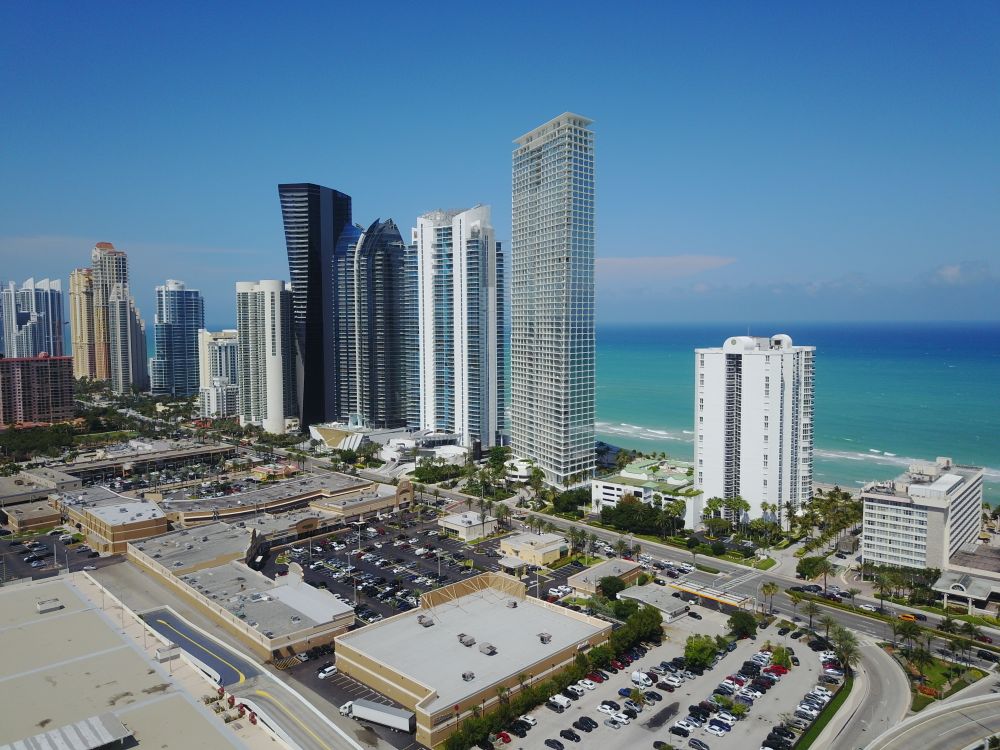 Aerial view of Sunny Isles Beach oceanfront branded condo towers along the Atlantic in Miami Florida