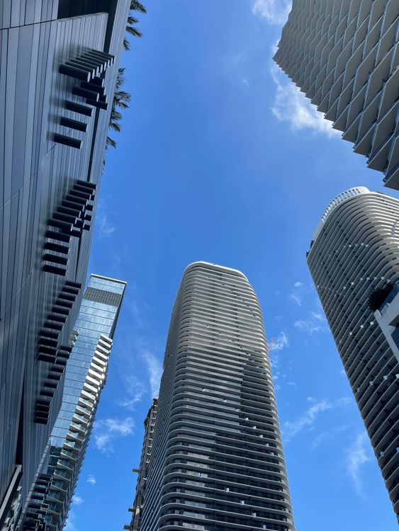 Miami luxury condo towers against a blue sky, benefiting from 2026 Florida insurance rate cuts