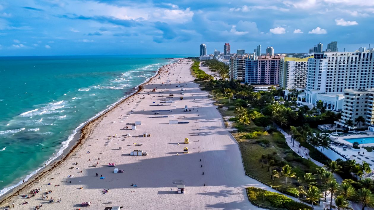 Aerial view of Miami Beach waterfront with luxury buildings along the Atlantic shoreline