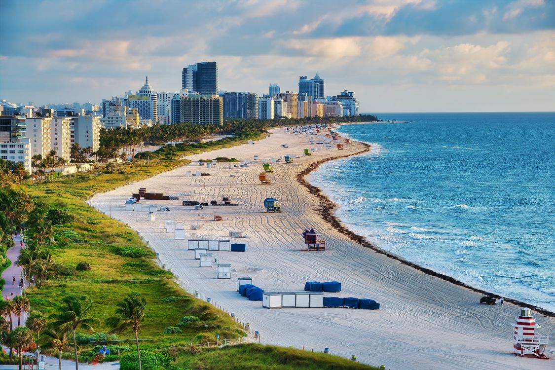 Miami Beach skyline and beach at dusk, representing South Florida's luxury coastal real estate market
