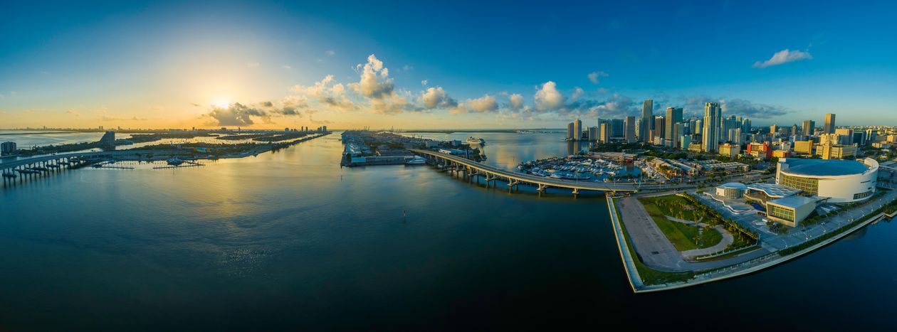 Aerial sunrise panorama over Biscayne Bay and downtown Miami, the relocation destination driving Florida's homestead exemption timing rules for out-of-state buyers