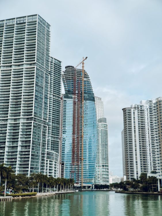 A Miami condo tower under construction with a crane on the waterfront, the pre-construction stage The Standard Residences has now moved past with its loan retired