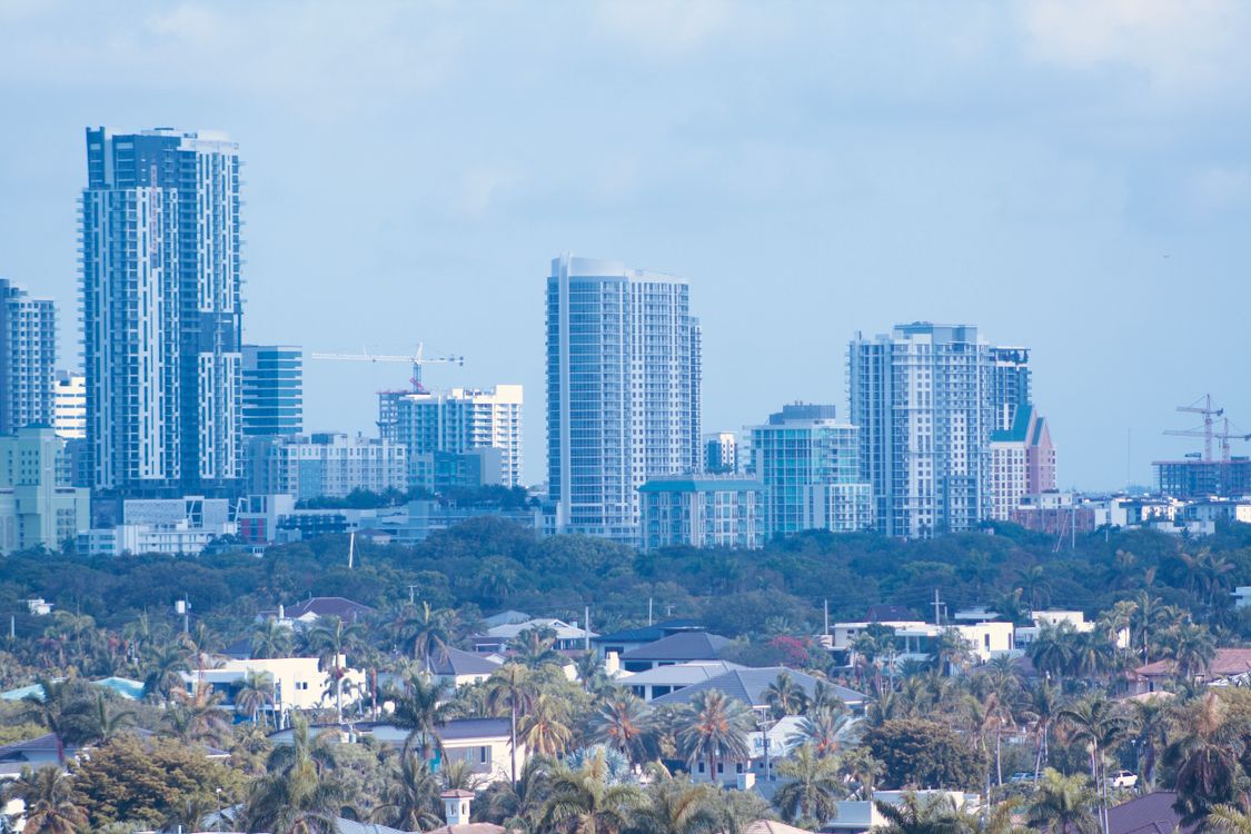 Miami skyline with luxury high-rises and construction cranes, the active pre-construction pipeline where most Miami towers are still selling well in 2026