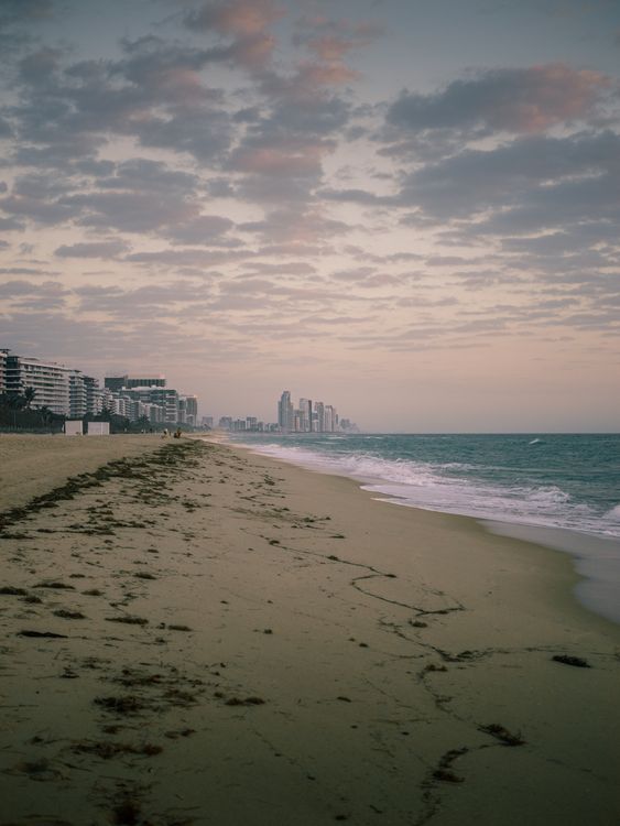 Surfside oceanfront beach at dusk with luxury condo towers, the South Florida market where DAMAC's Delmore has sold zero units