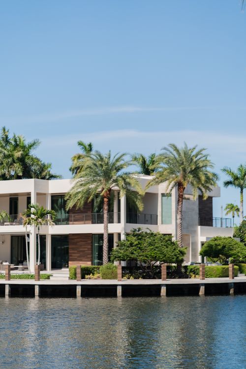 Waterfront luxury villa in Miami with palms and a private dock, the trophy single-family product that led the May 2026 sales surge