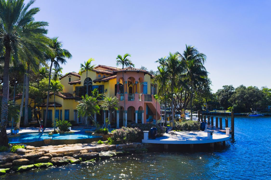 South Florida waterfront luxury estate with pool, dock, and palm trees, the trophy-home segment that tightens as relocating billionaires buy in Miami
