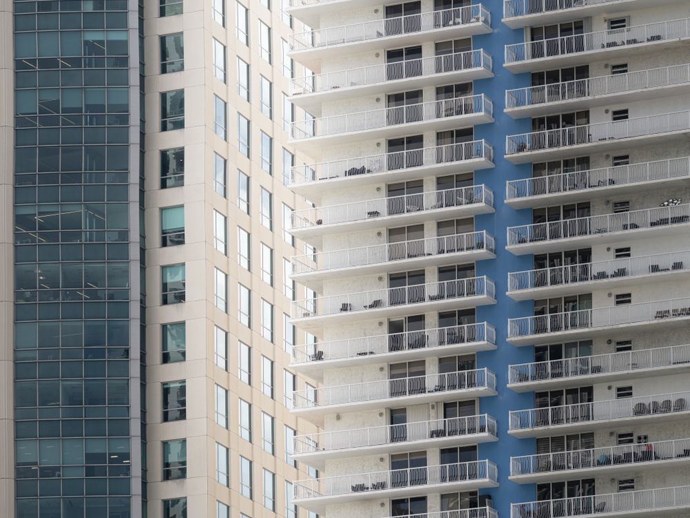 Close-up of a Miami luxury condo tower facade with balconies, the kind of building whose master insurance policy buyers now review before making an offer