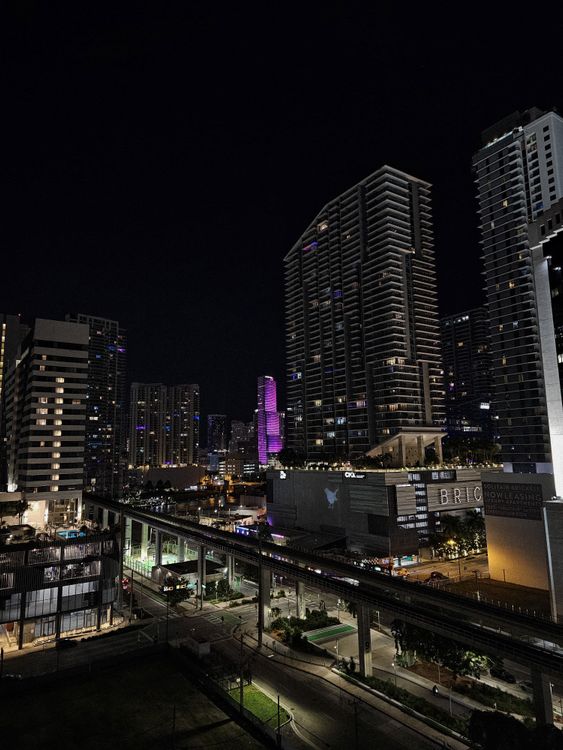 Brickell luxury condo towers lit up at night, the pre-construction submarket where foreign buyers use deposit schedules to average their exchange rate