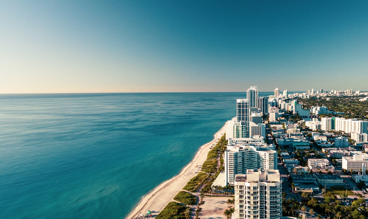 Aerial view of the Miami coastline and skyline over Biscayne Bay near Downtown Miami and 14 ROC