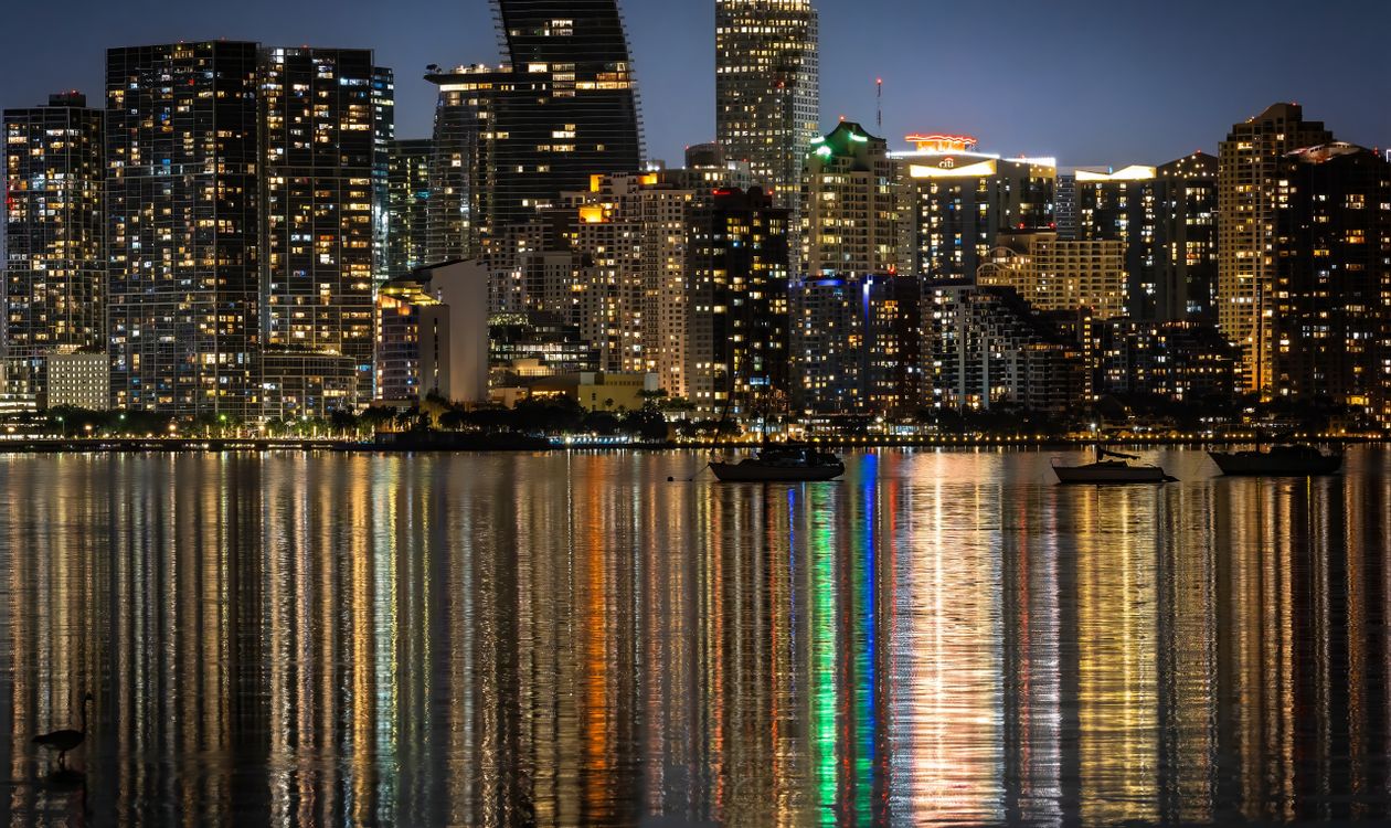 Brickell and downtown Miami luxury condo towers at night, the preconstruction market where deposits are locked for years before delivery