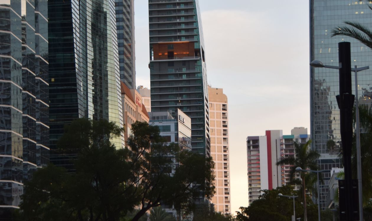 Brickell luxury condo glass towers at dusk, the preconstruction product where buyers commit 30 to 50 percent in staged deposits