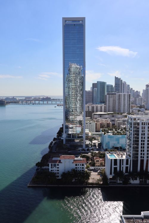 Slender glass boutique condo tower on the Miami waterfront, illustrating Aventura's boutique development trend as LEV breaks ground in 2026