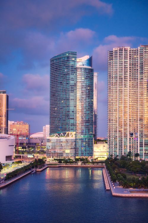 Miami condo towers at twilight near the water, the corridor Aventura buyers weigh against boutique product