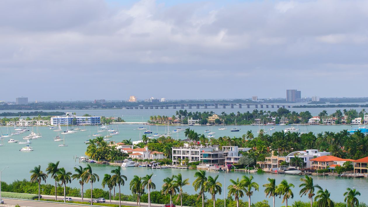 Aerial of Biscayne Bay waterfront homes and islands where Miami luxury inventory is stacking up in 2026