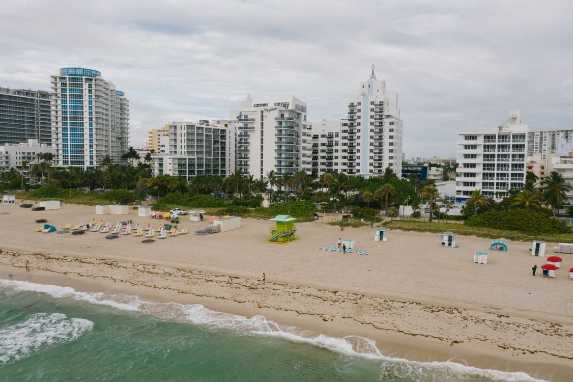 Aerial view of Miami Beach oceanfront condo buildings lining the sand, showing capped beachfront supply