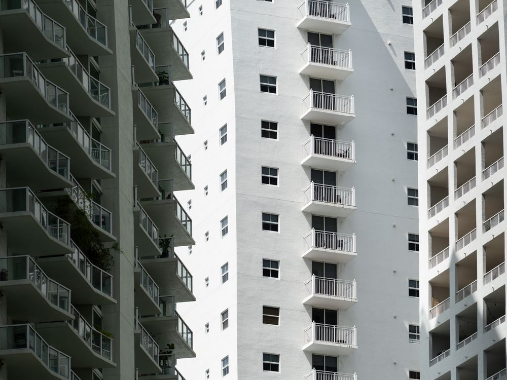 Miami residential apartment tower facades with rows of balconies, the multifamily rental product Live Local tax exemptions make financeable