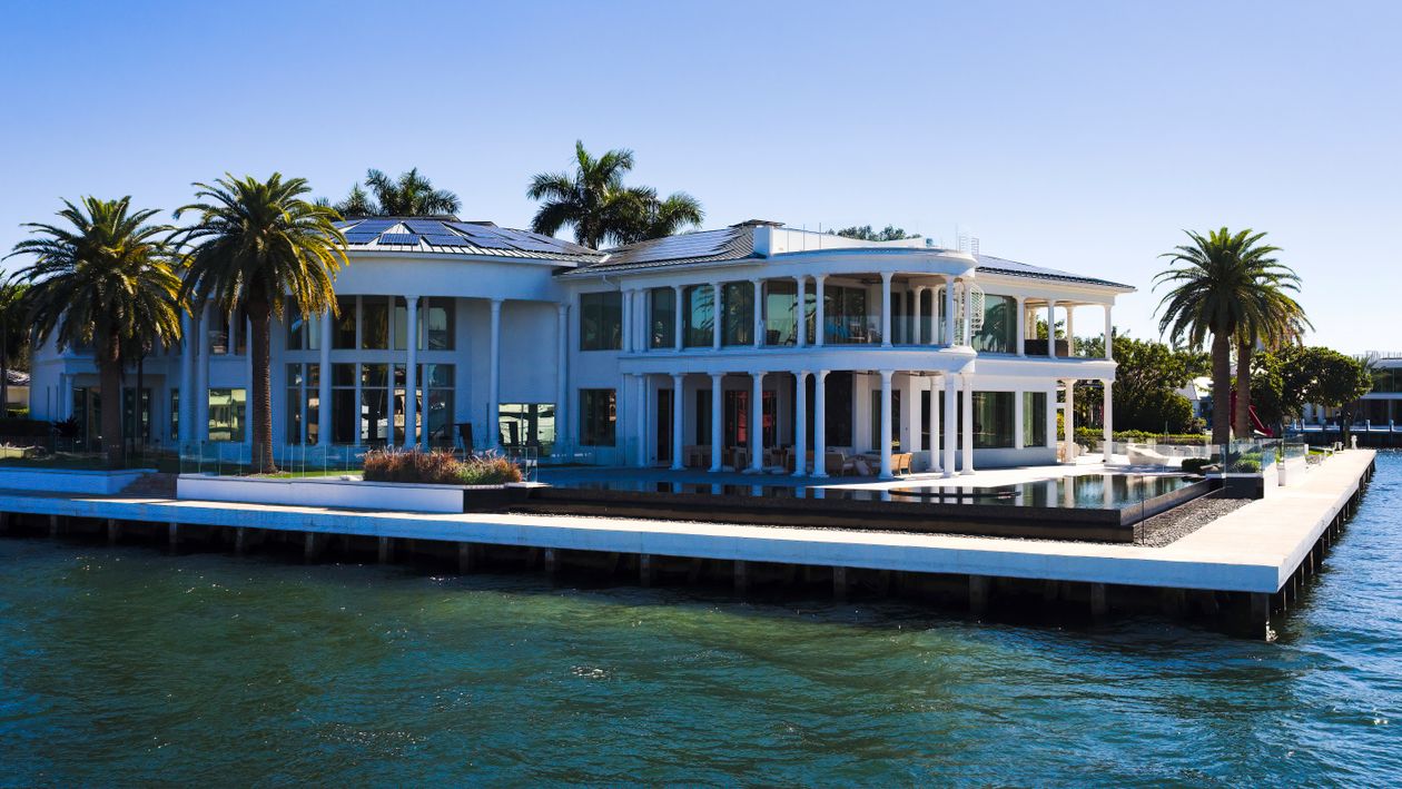 Waterfront new-construction estate with pool and private dock in a gated Miami enclave like Bay Point, setting a record price per square foot in 2026