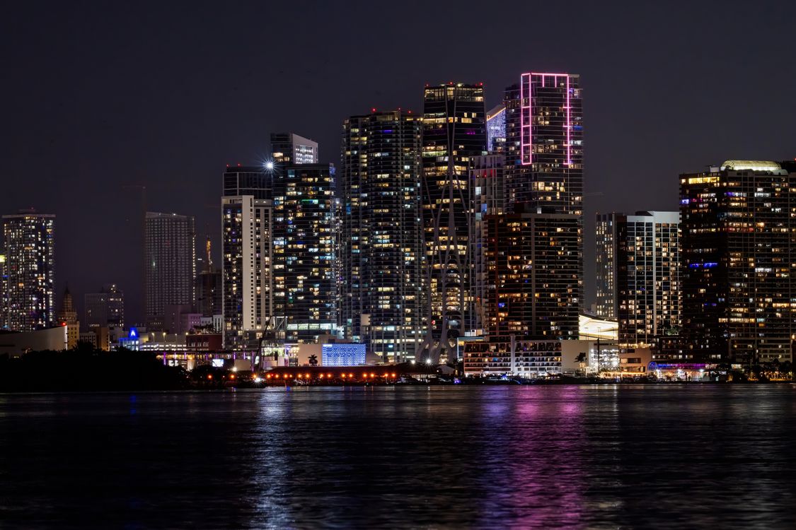 Miami skyline seen across Biscayne Bay at night from the waterfront neighborhoods to the north