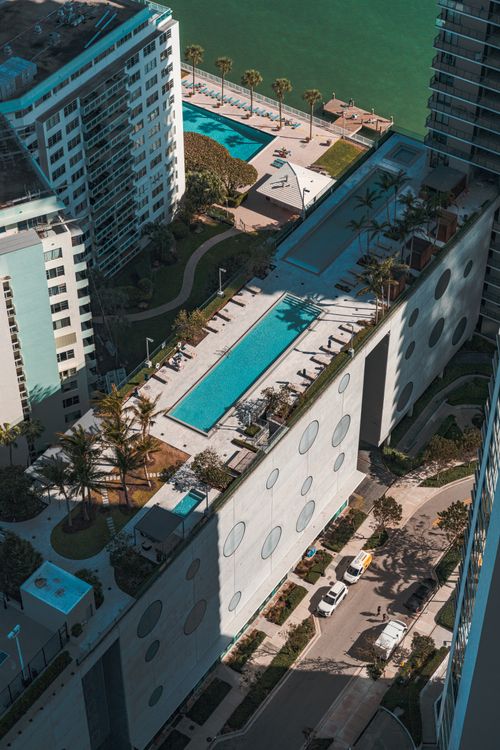 Miami waterfront luxury towers with pool decks overlooking Biscayne Bay
