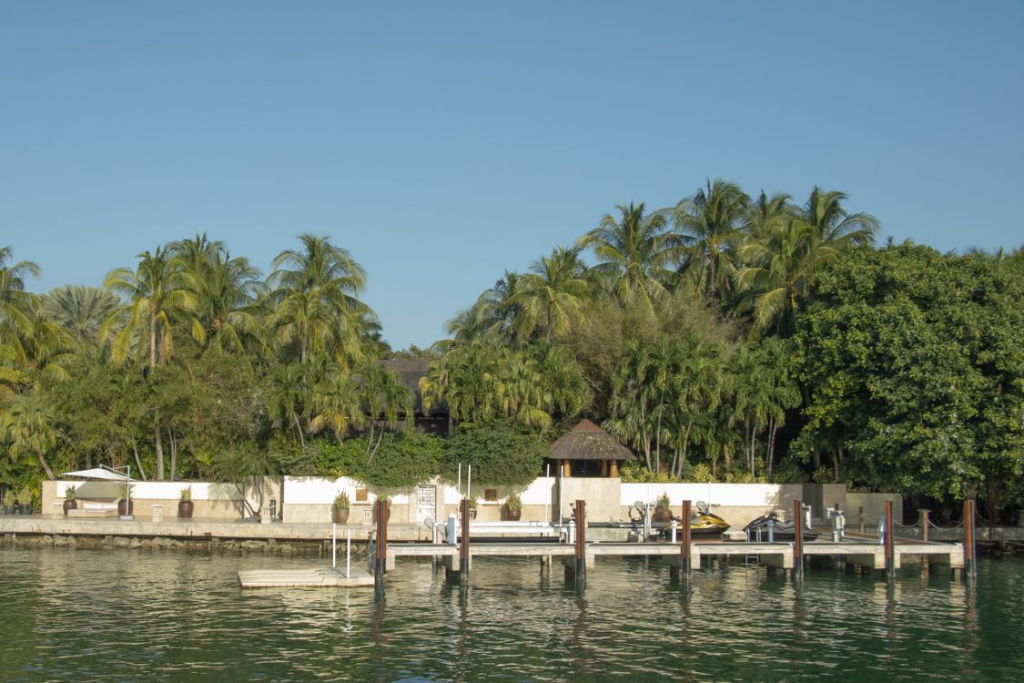 Palm-lined Miami waterfront estate with a private dock and jet skis, part of the top-tier market Redfin priced at a $4.9M median
