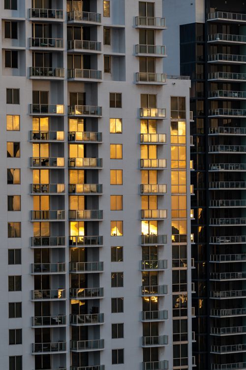 Lit Miami condo units at golden hour showing occupied residential towers
