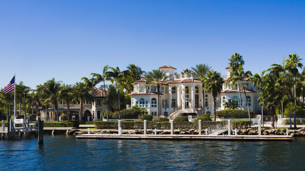 Waterfront luxury mansion with private dock on a Miami island, the property type leading July 2026 luxury contracts