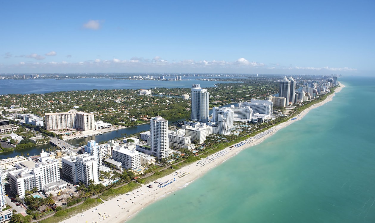 Aerial view of the Miami Beach oceanfront condominium corridor where out-of-state buyers concentrate in 2026