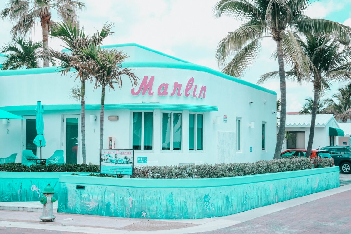 Art Deco style beachside building with palm trees on Hollywood Beach, Florida