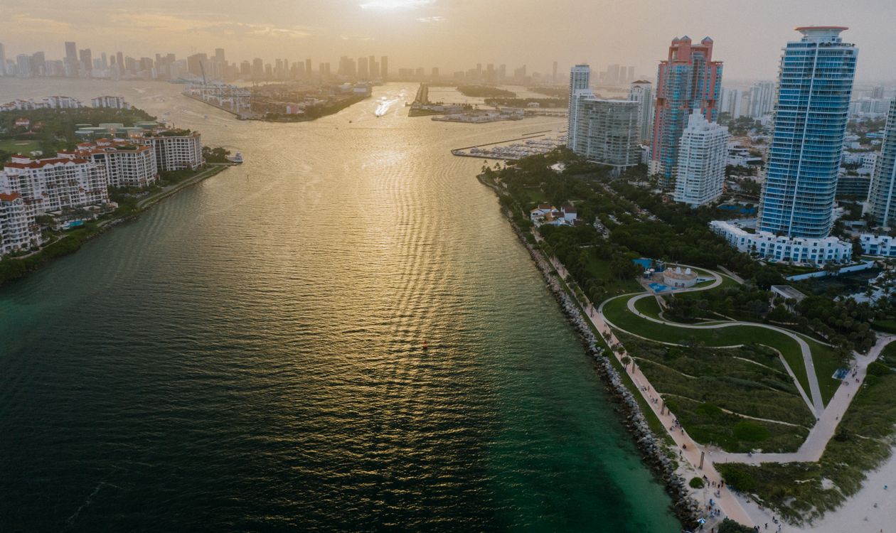 Aerial view over Government Cut at sunset with Fisher Island on the left and the Miami skyline behind