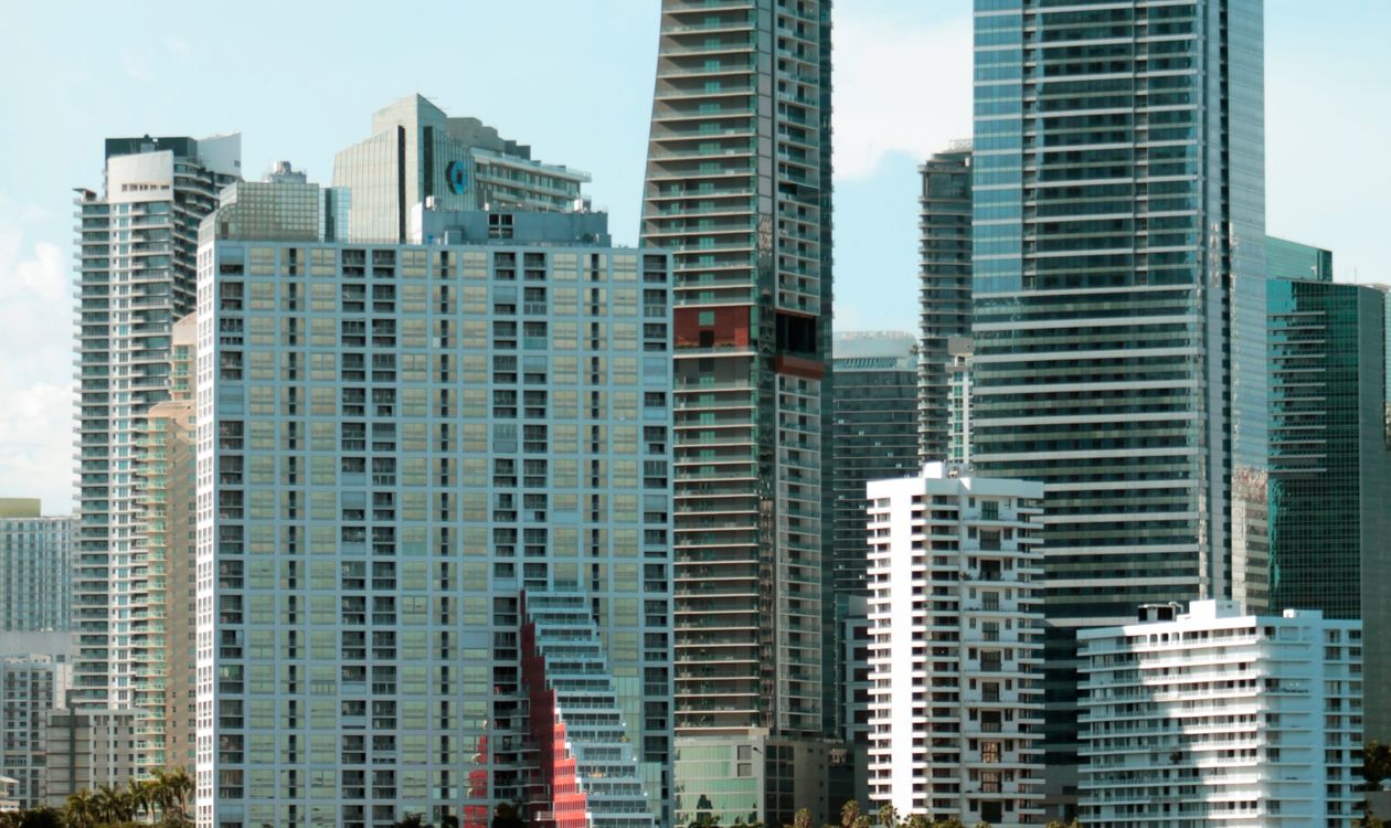 Cluster of Brickell condominium towers of different eras seen across Biscayne Bay in Miami