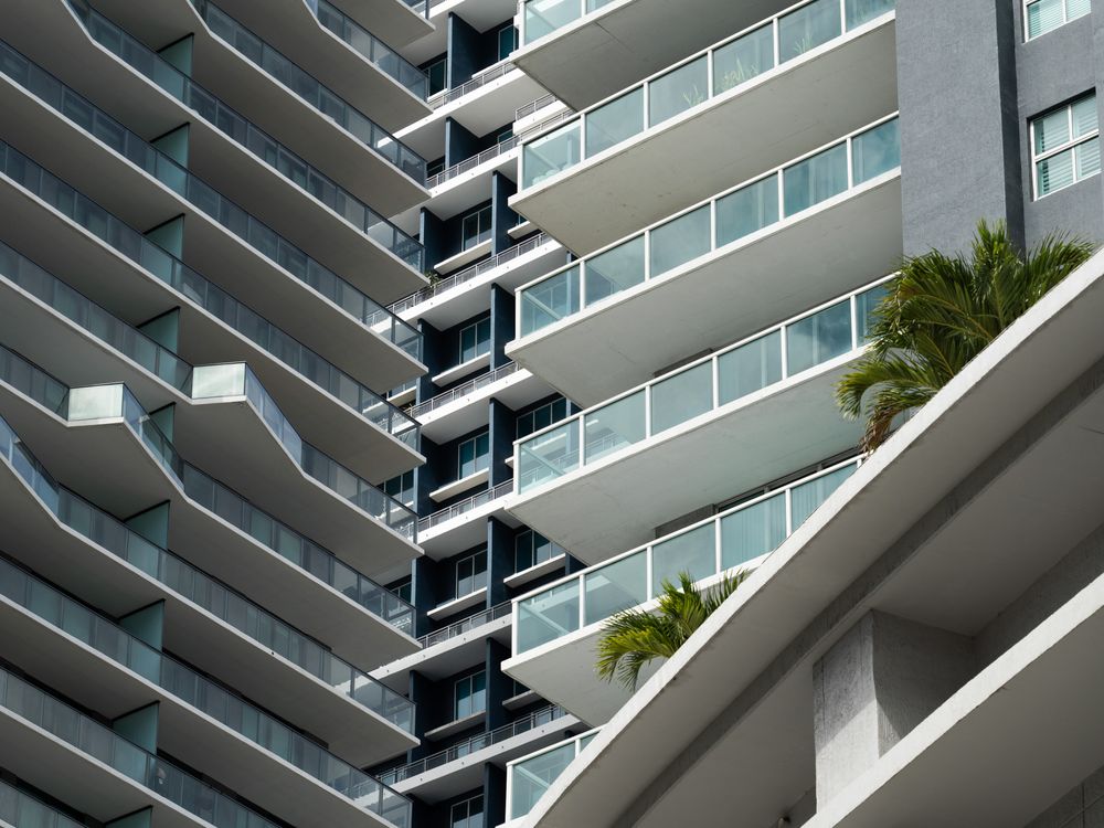 Two Miami condominium towers seen close up, their balcony stacks filling the frame, representing the units financed by a project's capital stack