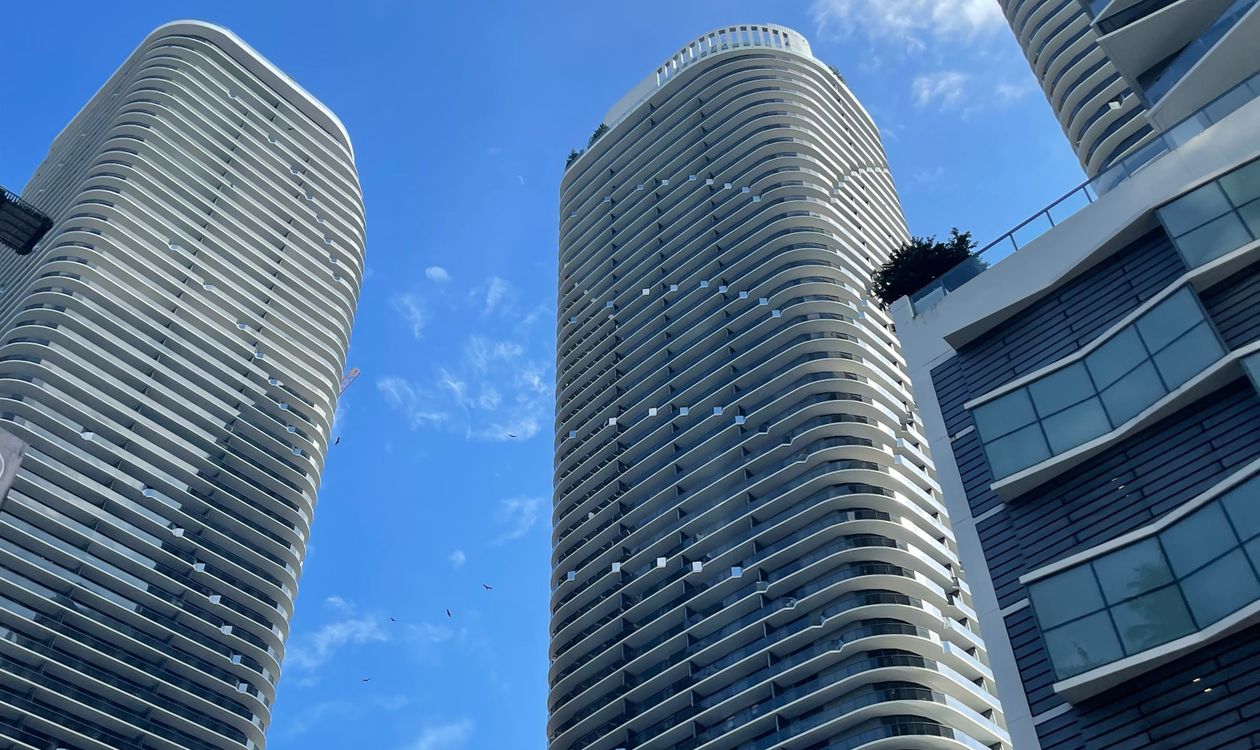 Miami condominium towers seen from street level, now subject to Full Review under the August 2026 condo lending rules