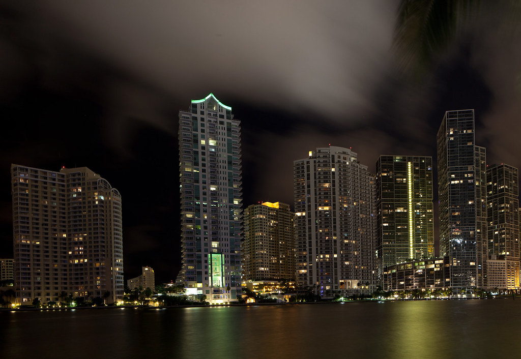 Brickell financial district condo towers lit at night along Biscayne Bay in Miami