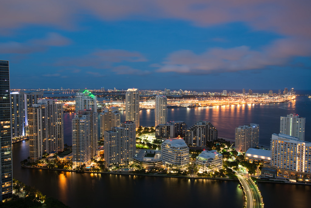 Aerial view of the Brickell financial district skyline with glass luxury condo towers along Biscayne Bay in Miami