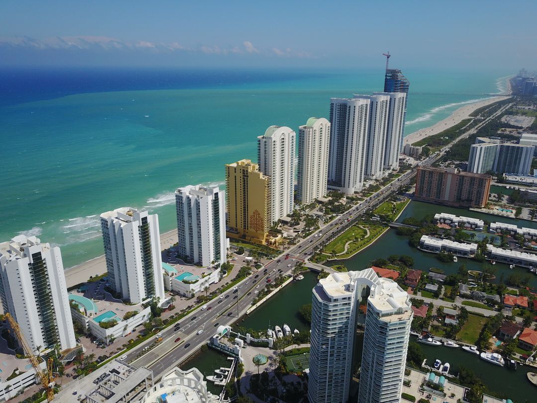 Aerial view of the Sunny Isles Beach oceanfront condo tower corridor along Collins Avenue in Miami-Dade