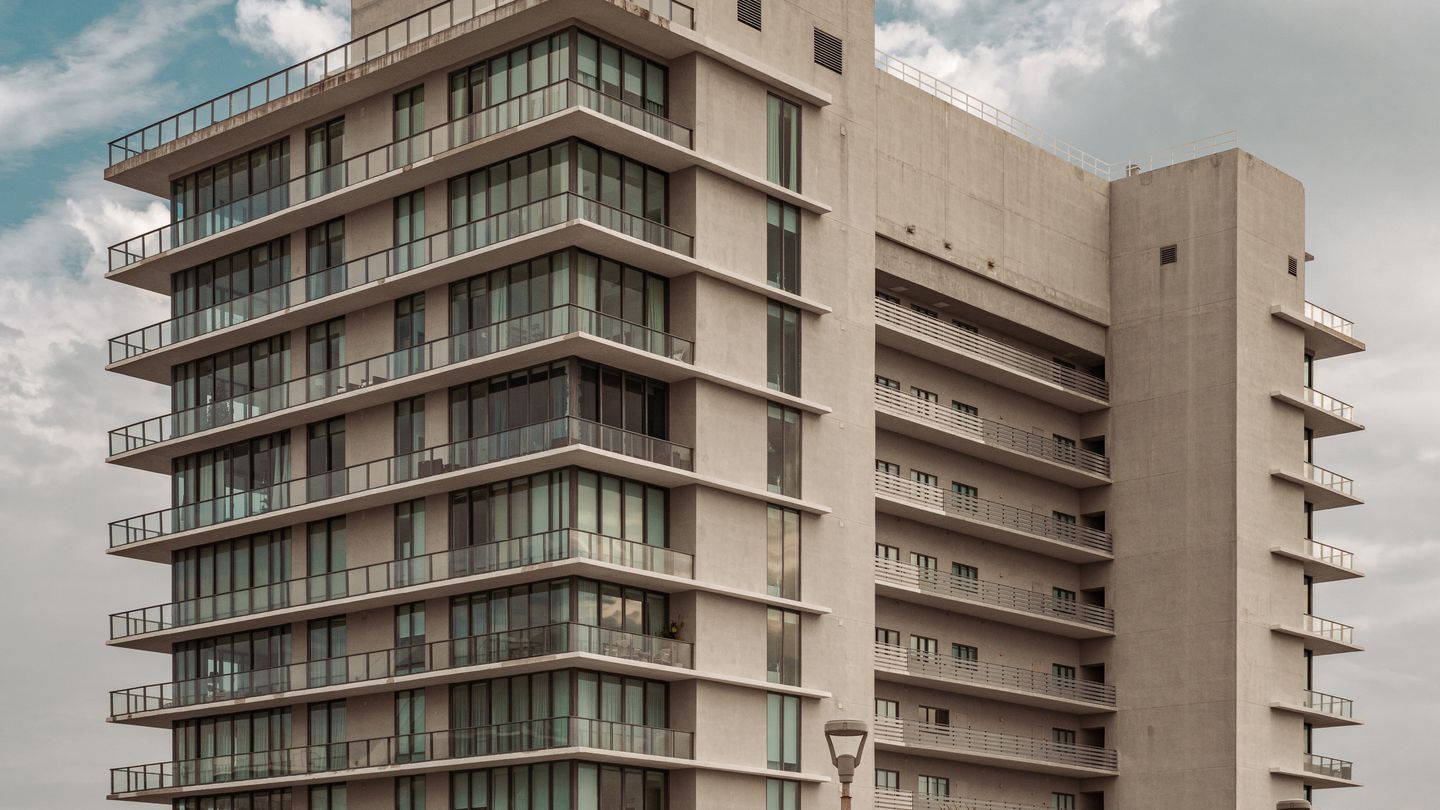 Close-up of a Miami condo tower concrete facade and balconies, the structural components a milestone inspection examines