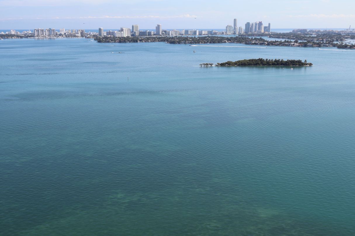 Aerial view of the Miami bayfront skyline and Biscayne Bay coastal waters spanning the Edgewater and Coconut Grove corridors