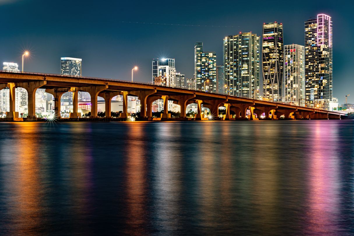 Venetian Causeway over Biscayne Bay with downtown Miami luxury condo towers at night