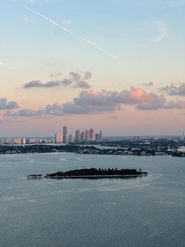 Biscayne Bay islands and the Miami Beach luxury skyline at sunset, aerial view
