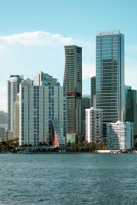 Brickell luxury condo towers on the Miami waterfront with a sailboat, daytime