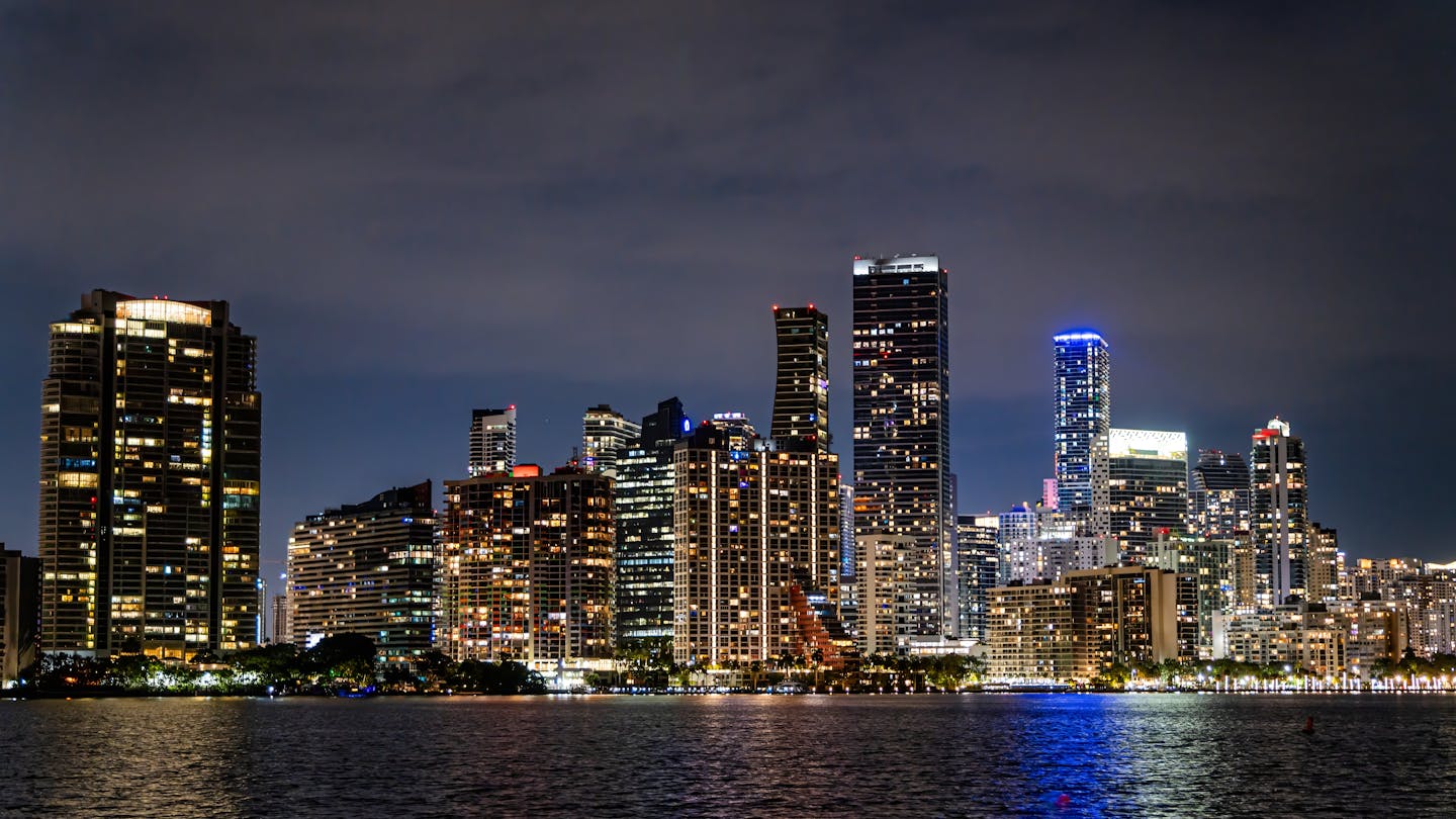 Brickell skyline at night where international capital concentrates in Miami pre-construction condos
